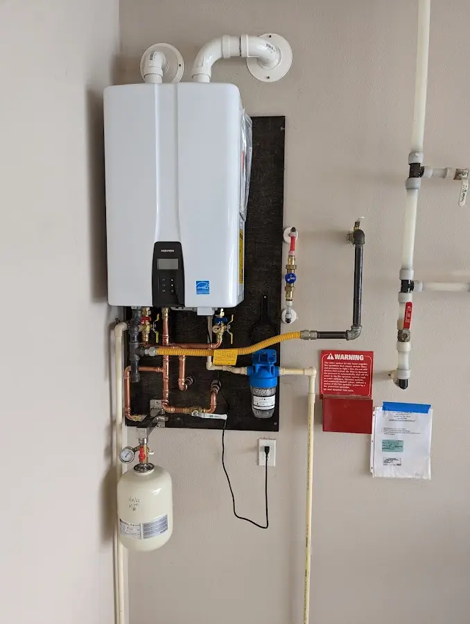 Professional plumber installing copper piping in a Town 'n' Country home